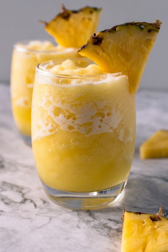 pineapple slushies with a pineapple garnish